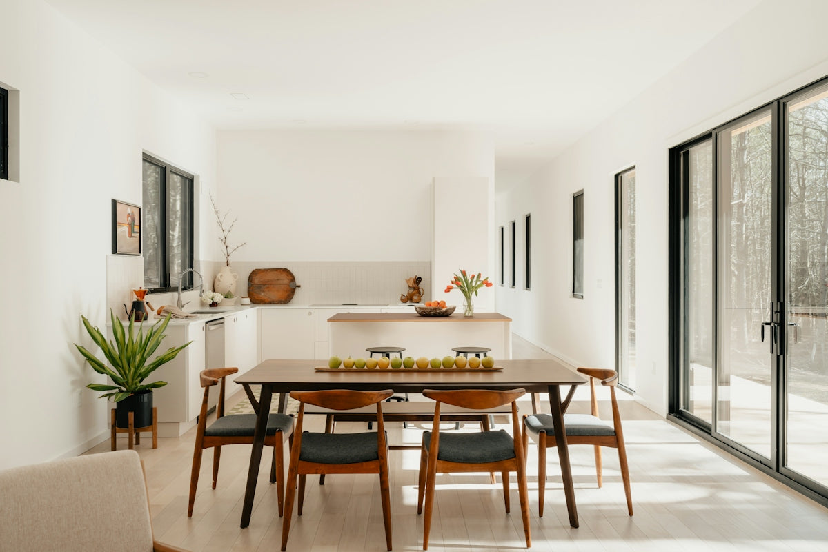 Modern dining room with table, chairs, and kitchen